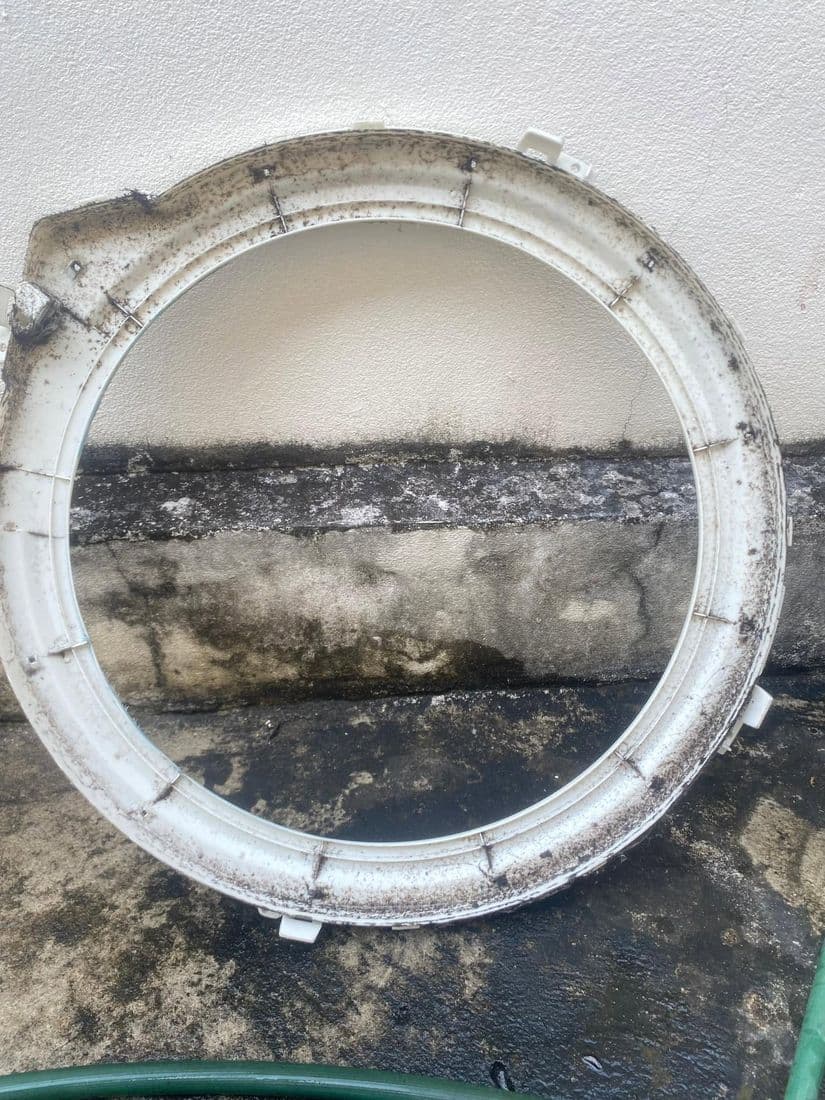 วงแหวนขอบถังวางบนพื้นปูน เห็นคราบราดำเรียงเป็นเส้นตามร่องด้านใน
