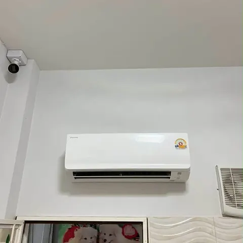 แอร์ติดผนังเครื่องใหม่บนผนังห้อง มีกล้องวงจรปิดติดอยู่ตรงมุมเพดาน